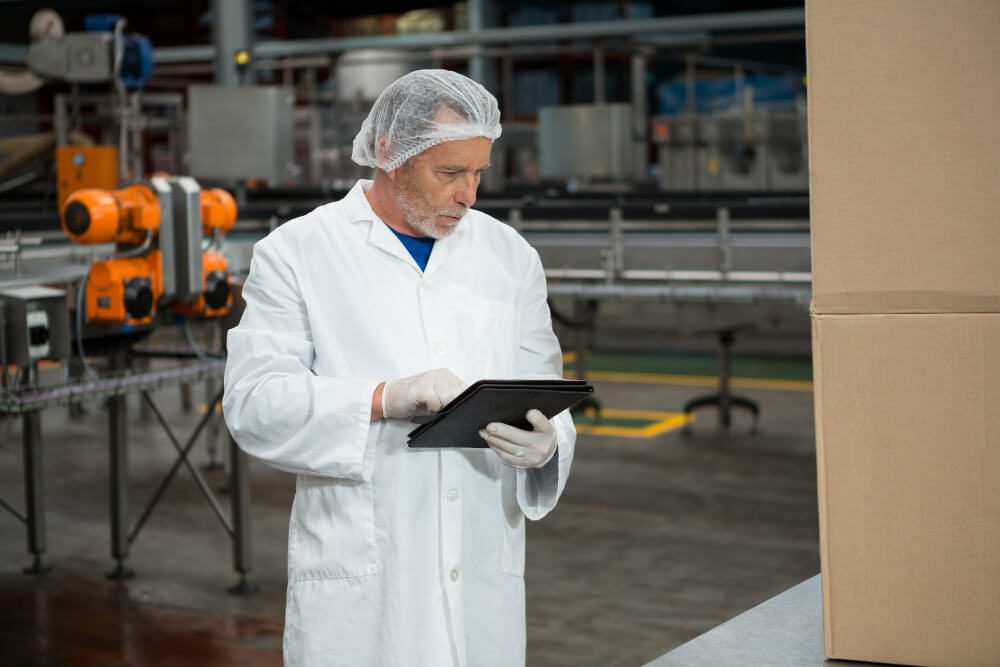 male-worker-using-digital-tablet-cold-drink-factory (1)